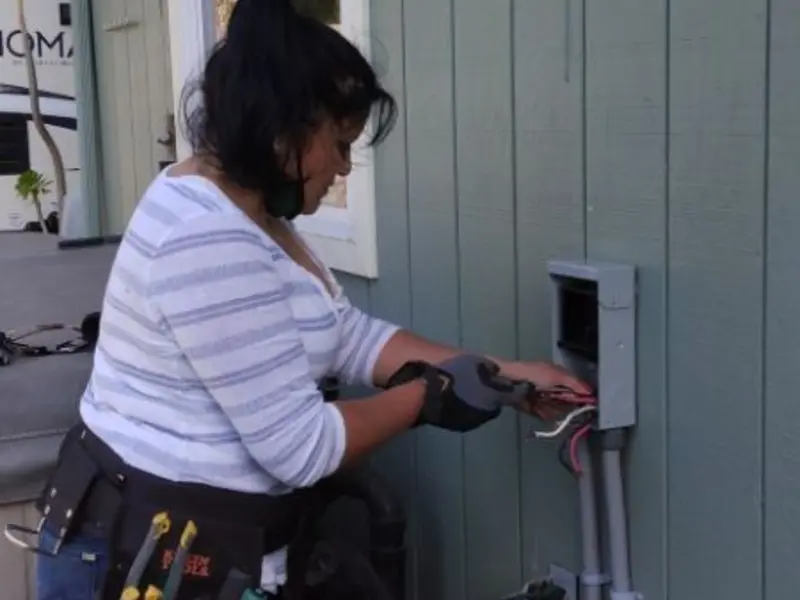 Licensed electrician wiring an exterior subpanel in Los Osos
